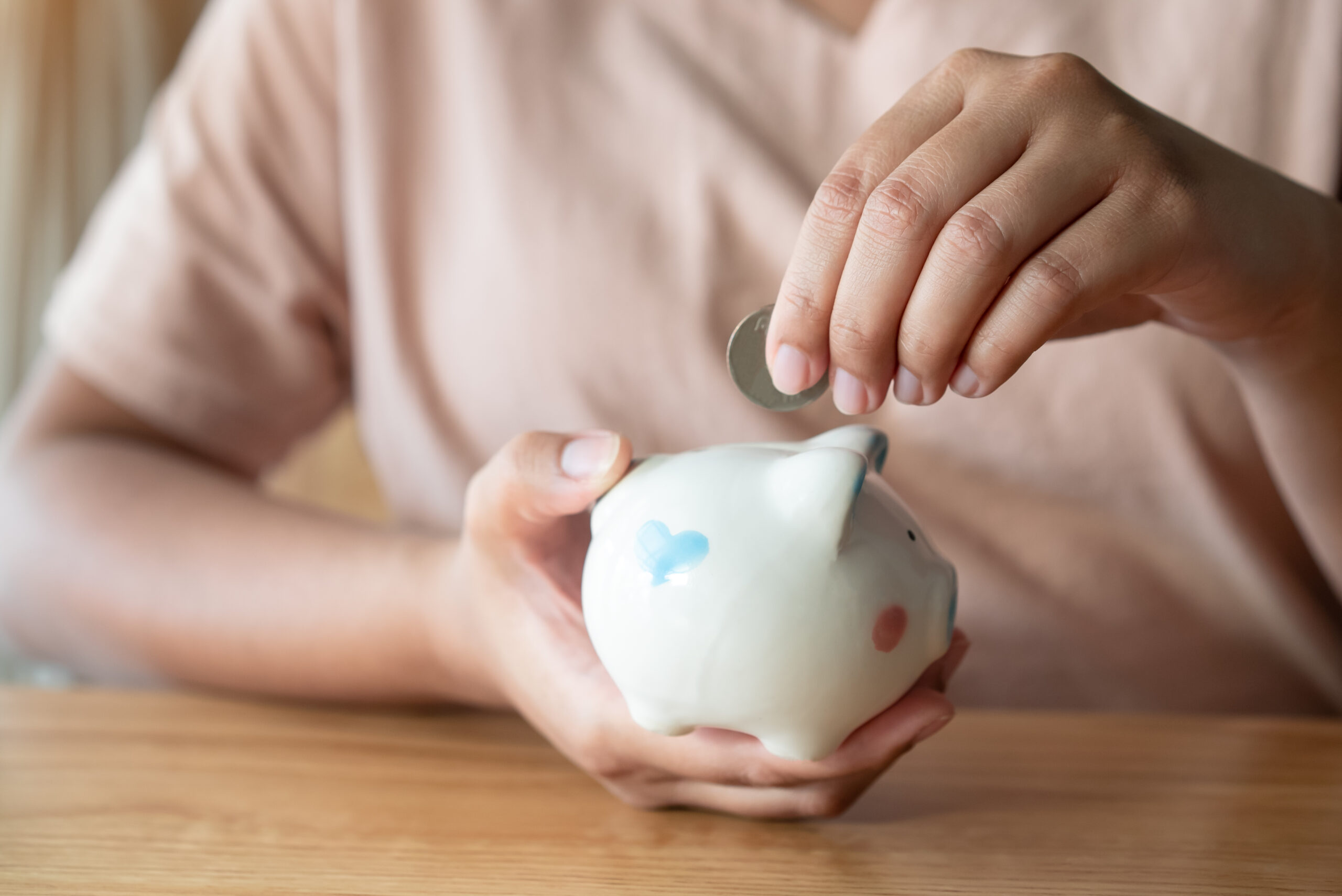 Adult Hand Saving Putting Coin Into A Piggy Bank 2022 11 11 04 36 48 Utc 300x200
